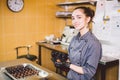 Subject profession and cooking pastry. young Caucasian woman with tattoo of pastry chef in kitchen of restaurant preparing round Royalty Free Stock Photo