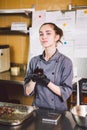 Subject profession and cooking pastry. young Caucasian woman with tattoo of pastry chef in kitchen of restaurant preparing round Royalty Free Stock Photo