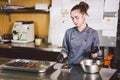 Subject profession and cooking pastry. young Caucasian woman with tattoo of pastry chef in kitchen of restaurant preparing round