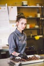 Subject profession and cooking pastry. young Caucasian woman with tattoo of pastry chef in kitchen of restaurant preparing round Royalty Free Stock Photo