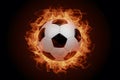 Subject Soccer ball surrounded by fiery flames in dramatic illumination Royalty Free Stock Photo