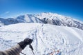 Subjective personal view of alpin skier on snowy slope ready to start skiing. Expansive fisheye panorama of the italian Alps with