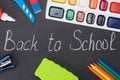 Subjects for creativity lie on a board on which is written chalk `back to school` Royalty Free Stock Photo