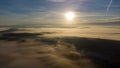 Sublime scenery of beautiful sunrise above clouds over mountains