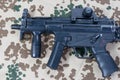 Modern submachine gun MP5 on desert camouflaged background Royalty Free Stock Photo