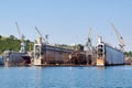 Submarine and ship under repairing by technical team in floating dry docks Royalty Free Stock Photo