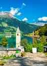 Submerged Bell Tower of Curon and a cemetery on Lake Reschen in South Tyrol, Italy