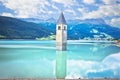 Submerged bell Tower of Curon Venosta or Graun im Vinschgau on Lake Reschen landscape view