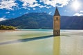 Submerged bell Tower of Curon Venosta or Graun im Vinschgau on Lake Reschen sun haze view Royalty Free Stock Photo