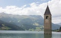 Submerged tower of reschensee church deep in Resias Lake in Trentino-Alto valley Royalty Free Stock Photo