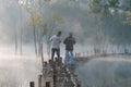 Submerged trees reflecting on lake with the magic light, fog and people active at sunrise part 5 Royalty Free Stock Photo