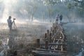 Submerged trees reflecting on lake with the magic light, fog and people active at sunrise part 4 Royalty Free Stock Photo