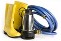 Submersible pump, rubber boots and water hose Royalty Free Stock Photo