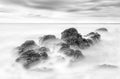 Submersion of the rocks on a heaven ocean, black and white beach landscape Royalty Free Stock Photo