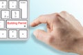 SUBMITTING FOR A BUILDING PERMIT CONCEPT with fictional Building Permit and text written over computer keyboard