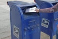 Submitting a Vote by Mail Ballot in a Blue USPS Mailbox Royalty Free Stock Photo