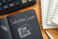 Subprime loan is shown on the business photo using the text