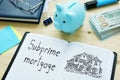 Subprime mortgage is shown on the business photo using the text