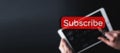 Subscribe button. Online video subscription red button. Internet service on laptop digital tablet blured banner