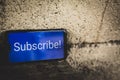 subscribe text in smartphone blue screen Royalty Free Stock Photo