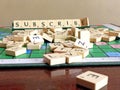 Subscribe word written on scrabble for content creation Royalty Free Stock Photo