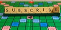 Subscribe word written on scrabble for content creation Royalty Free Stock Photo