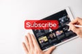 Subscription plan. Red online video subscribe button. Internet service on laptop digital tablet blured technology