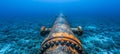 Subsea oil and gas pipeline metal conduit for underwater transport in blue ocean depths Royalty Free Stock Photo