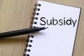 Subsidy write on notebook Royalty Free Stock Photo