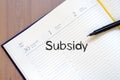 Subsidy write on notebook Royalty Free Stock Photo