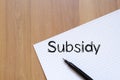 Subsidy write on notebook Royalty Free Stock Photo