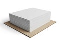 A substantial stack of blank white paper sheets rests on a sturdy cardboard base Royalty Free Stock Photo