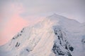 Subtle alpenglow lights snowy mountain