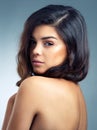 Subtle but oh so stunning. Studio portrait of a beautiful young woman posing against a gray background.