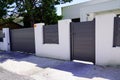 Suburb home grey brown dark metal aluminum gate slats portal access house door