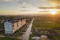 Suburb landscape, apartment building. Parked cars along bad road on spring day on blue sky copy space background Royalty Free Stock Photo