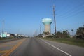 Suburban America, Texas, United States. Perspective landscape view of a road, highway with water tower and power poles.