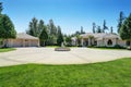 Suburban family house with fountain statue in the front yard