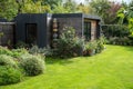 Suburban garden in London UK, with sustainable eco friendly garden studio room with green living sedum  roof. Royalty Free Stock Photo