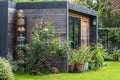 Suburban garden in London UK, with sustainable eco friendly garden studio room with green living sedum  roof. Royalty Free Stock Photo