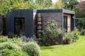 Suburban garden in London UK, with sustainable eco friendly garden studio room with green living sedum  roof. Royalty Free Stock Photo