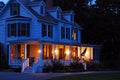 A suburban home is lit at dusk Royalty Free Stock Photo