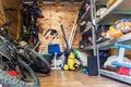 Suburban home wooden storage utility unit shed with miscellaneous stuff on shelves, bikes, exercise machine, ladder Royalty Free Stock Photo