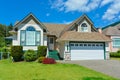 Suburban house with concrete driveway and blue sky background. House for sale Royalty Free Stock Photo