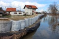 Suburban houses protected with sandbox barrier flood protection from rising river