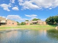 Suburban lakefront houses with water fountain and green grass lawn near Dallas Royalty Free Stock Photo