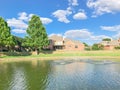 Suburban lakefront houses with water fountain and green grass lawn near Dallas Royalty Free Stock Photo