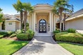 Suburban luxury house with column porch and arched entrance door