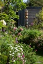 Messy bedhead garden in London UK with rock garden. Aquilegia flowers in the foreground.