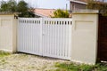 Suburban metal gate white fence on home suburb street access house garden Royalty Free Stock Photo